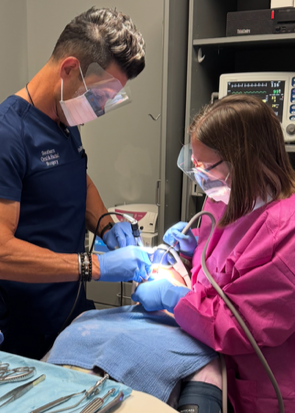 Dr. Fisher with a female staff with a patient